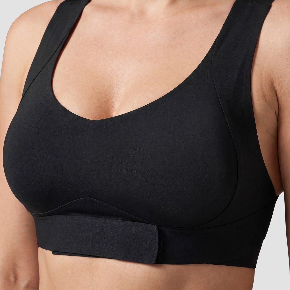 Close-up of the front-closure band on the Sculpt posture bra in black